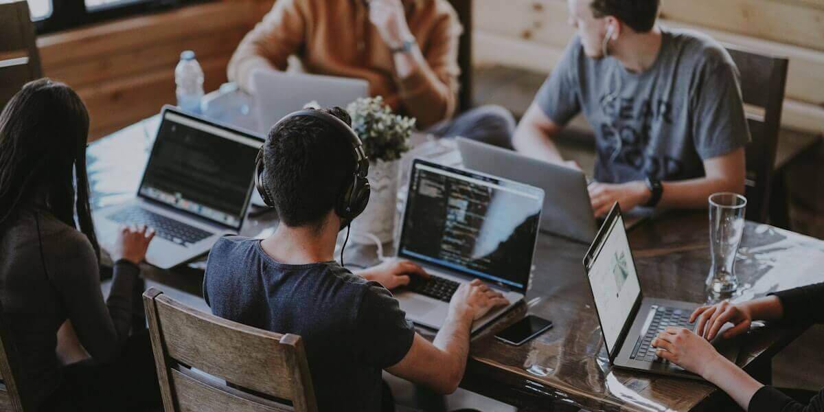 Engineers collaborating around a shared technical workspace